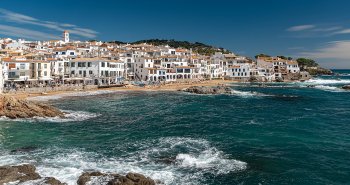 Playa de Port Bo en Calella de Palafrugell con barcas varadas y casas blancas de pescadores