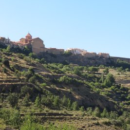 Cantavieja encaramada a su espolón rocoso sobre el barranco, con las montañas del Maestrazgo al fondo