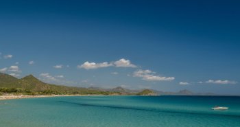Cala de aguas turquesas rodeada de acantilados en Cerdeña