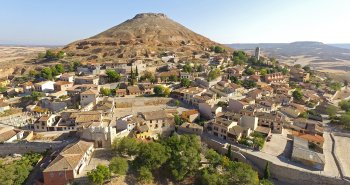 Vista de Hita (Guadalajara) al pie de su cerro, con la Puerta de Santa María y el caserío de la villa medieval