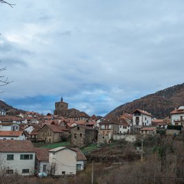 Vista panorámica de Isaba con sus tejados de piedra bajo la iglesia-fortaleza de San Cipriano y las montañas del Pirineo