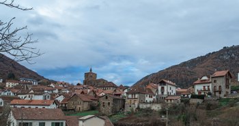 Vista panorámica de Isaba con sus tejados de piedra bajo la iglesia-fortaleza de San Cipriano y las montañas del Pirineo