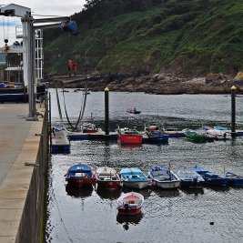 Vista panorámica de Tazones, con sus casas marineras de colores apiñadas sobre el pequeño puerto pesquero asturiano